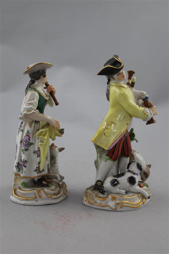 A pair of Meissen groups of a musical shepherd and shepherdess, 20th century, 16cm. and 15cm., minor losses to leaves